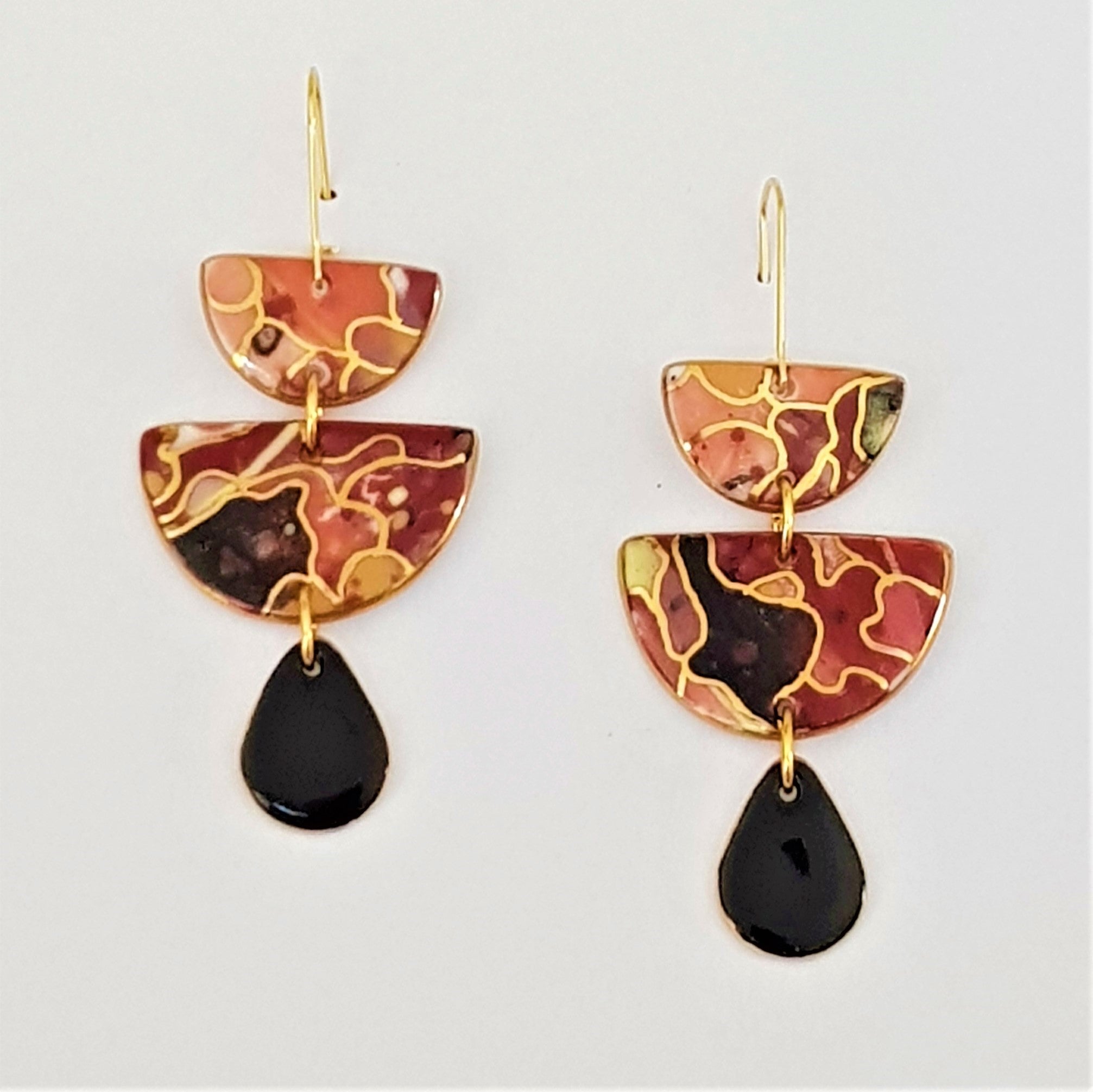 Triple drop earrings in warm tones and black with gold linework