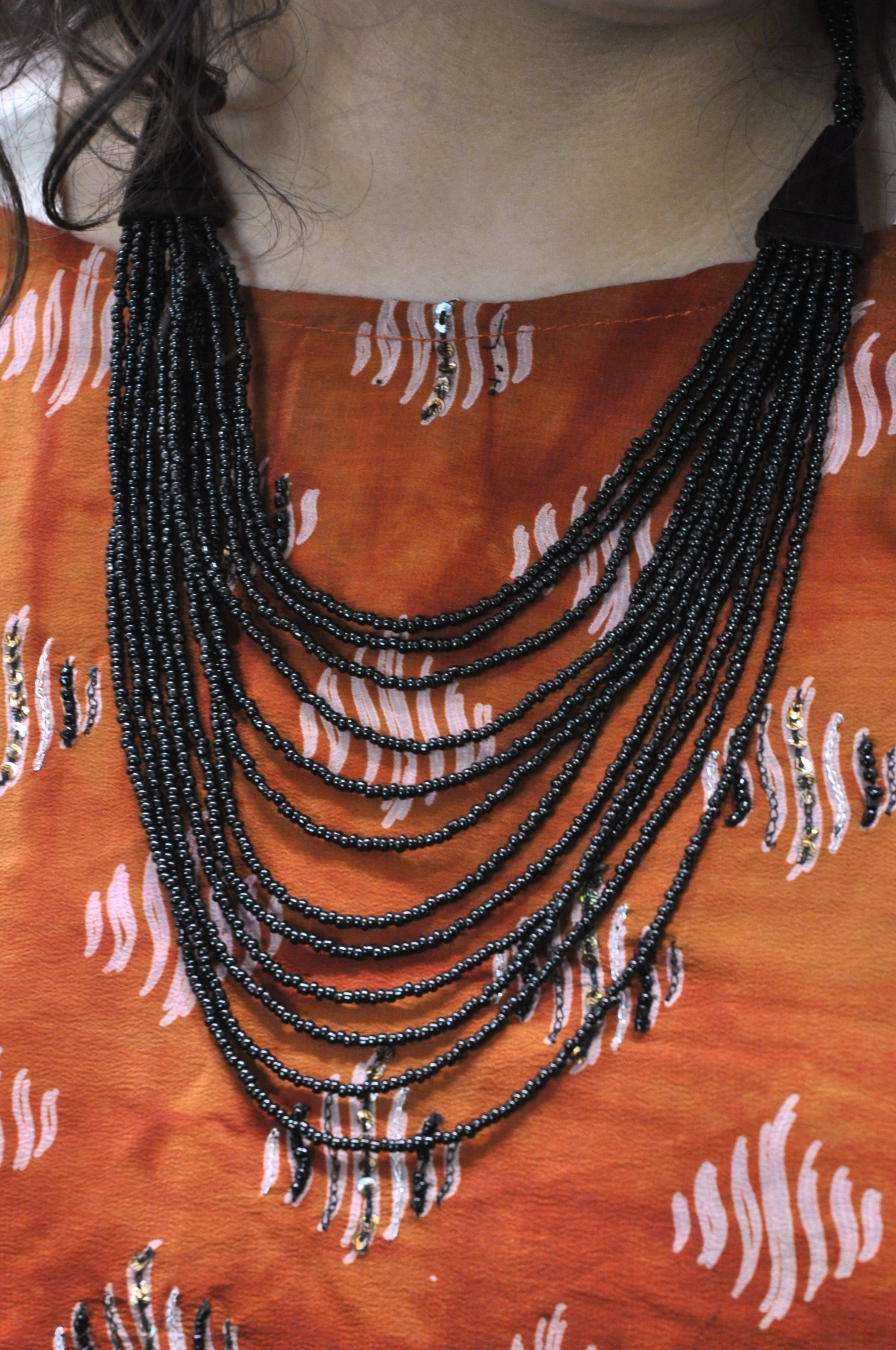 Multi Strand Necklace with Gold Toned Metal Bead Black
