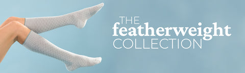 A pair of graduated compression socks in the air representing the featherweight collection