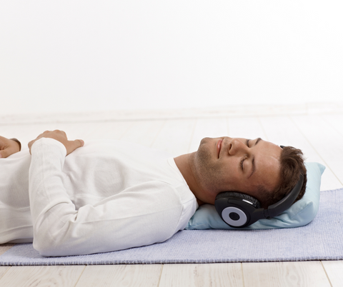 Man-headphones-yogamat-reduced-stress-anxiety-self-care