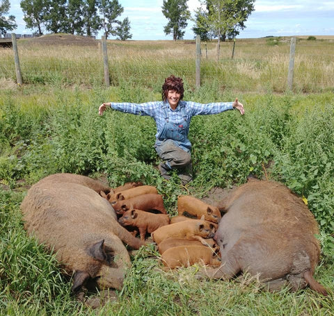 Christina from Eh Farms with two Mangalitsa sows and their piglets
