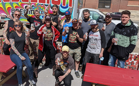 Rebellion Team photo, everyone holding Amber Ale