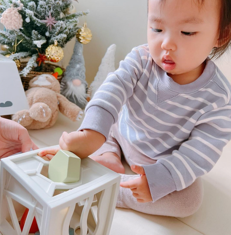 Baby using a silicone shape sorter toy