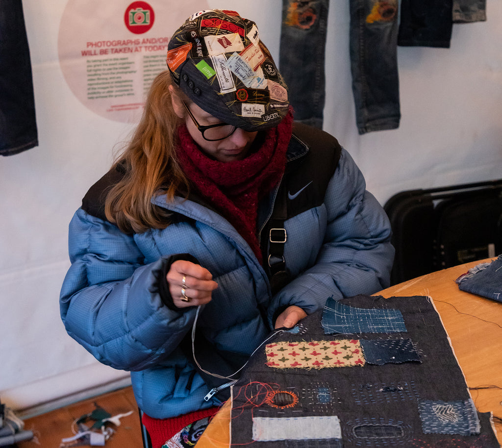 Barley Massey of Fabrications leads a workshop on visible mending using Sashiko-inspired techniques on denim.