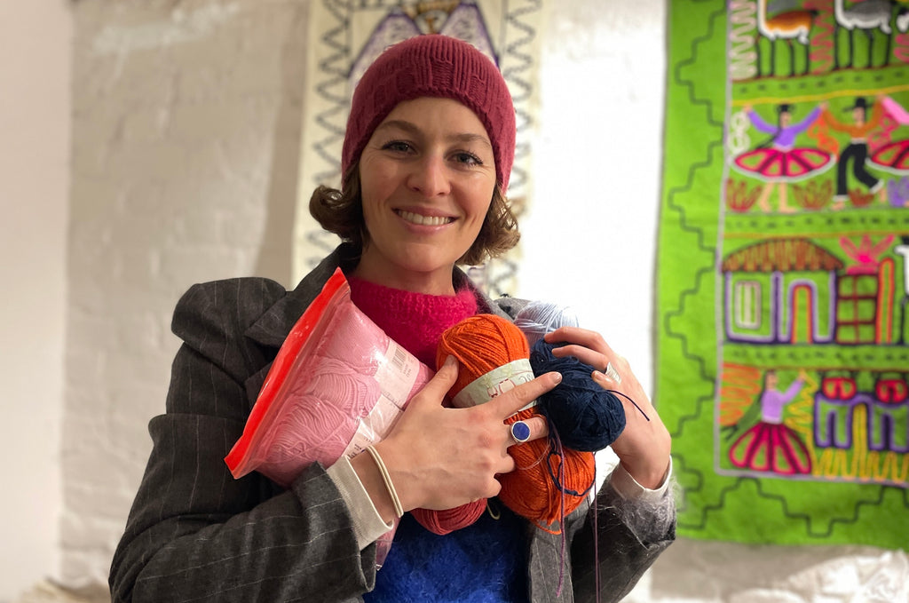 Margherita Deri holding bundles of yarn