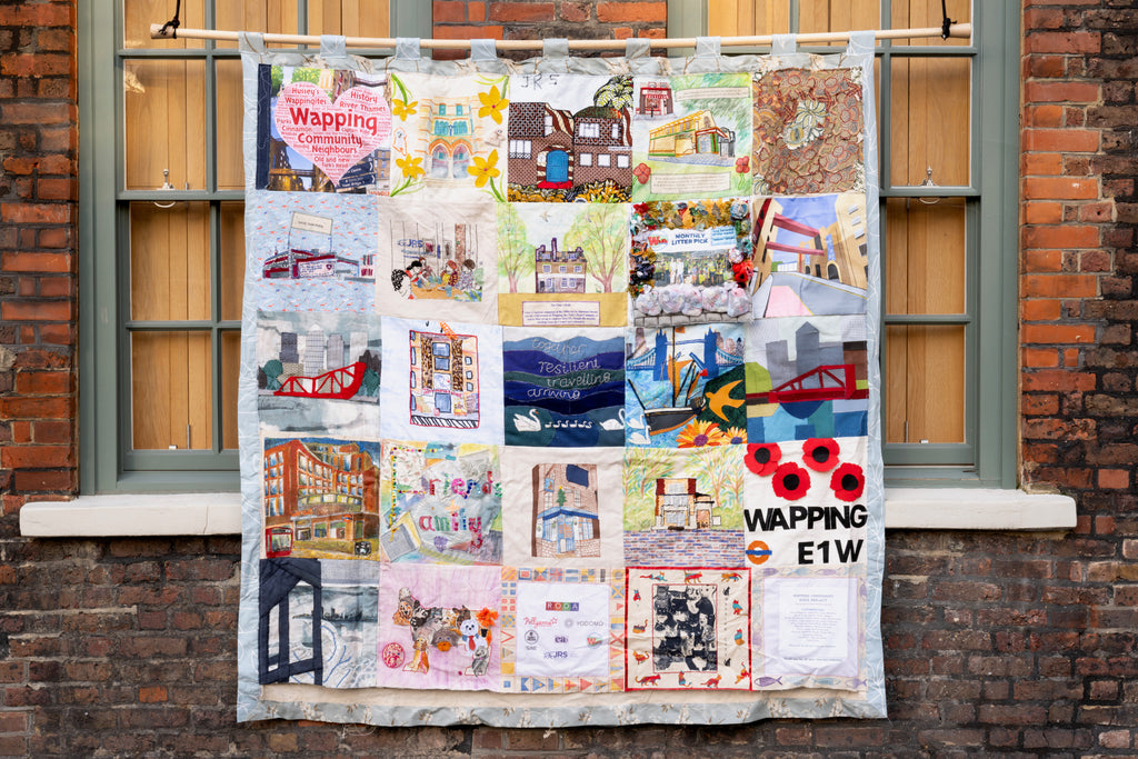 A quilt made of 16 squares of sewn and embroidered images.