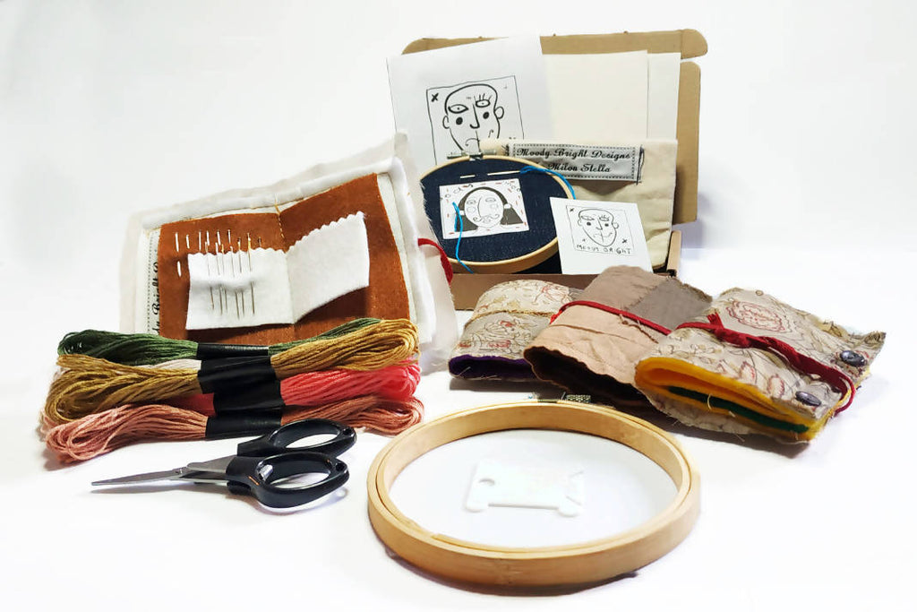 embroidery kit featuring handmade pouches, embroidery hoop, skeins, scissors and guide.