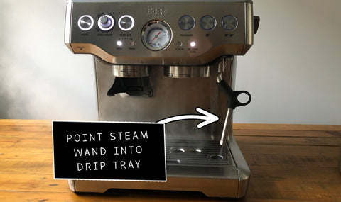 Pointing steam wand into drip tray