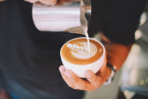 Pouring the frothy milk over the Espresso shot