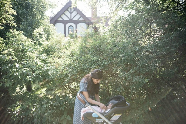 A mum tends to get baby in a stroller while out in nature