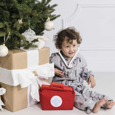 Boy Sitting with Le Toy Van Doctor Set during Christmas: Christmas Gifts