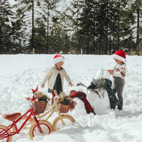 Kids playing in snow with Banwood Cycles. Great Christmas Gift!