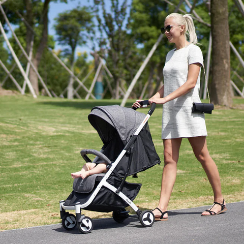 Mum pushing baby in pushchair