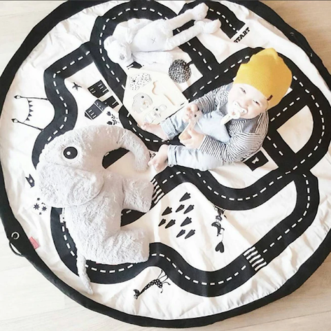 baby playing on educational playmat