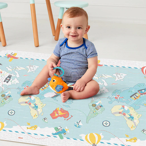 baby sitting on reversible playmat