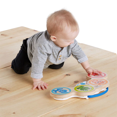 baby playing with drums on floor