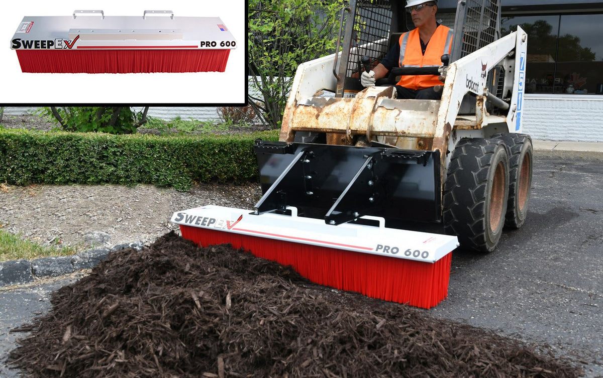 Bobcat sweeping dirt with broom