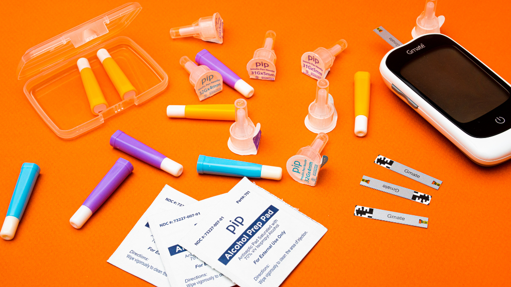 Orange background with diabetes supplies