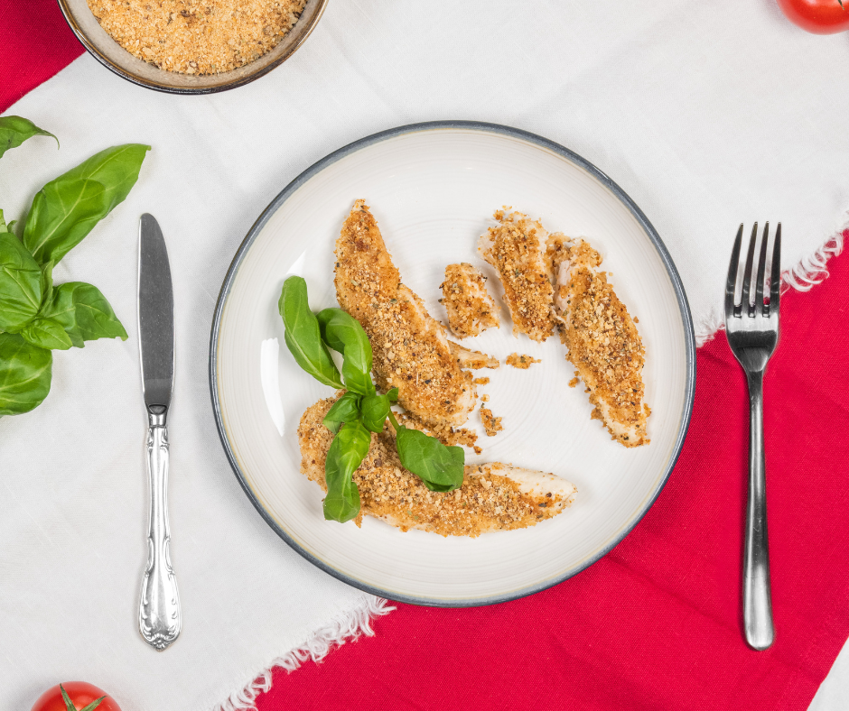 Chicken breaded with Cauliflower Crumbs served on a plate