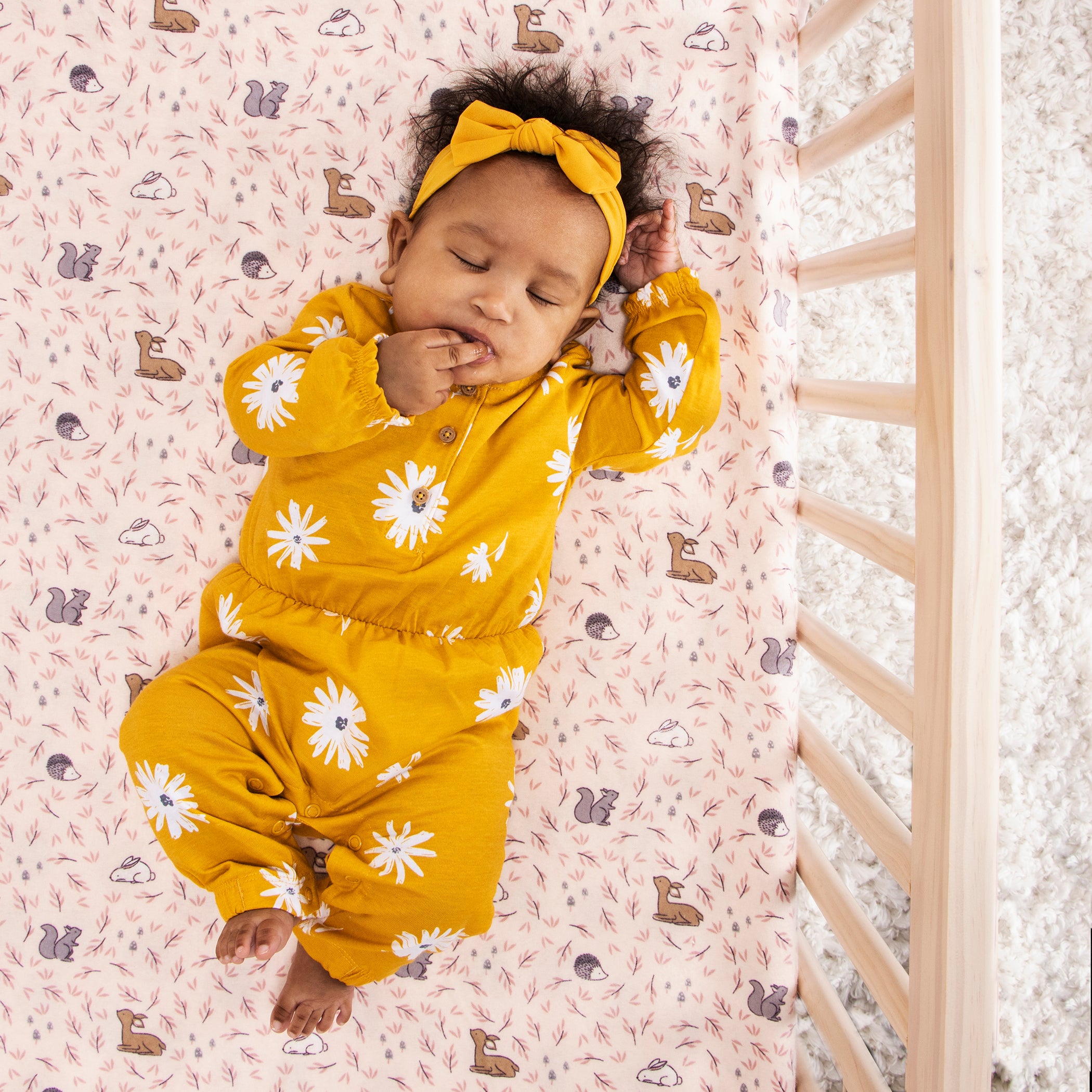 Sweet Baby Sleeping in crib with cute flannel sheet