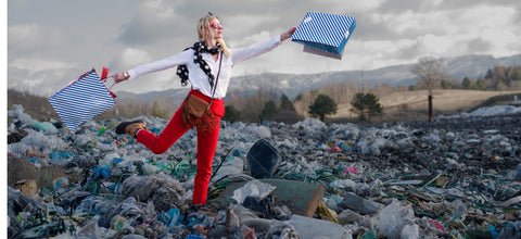 Shopper on top of Pile of Discarded Clothes
