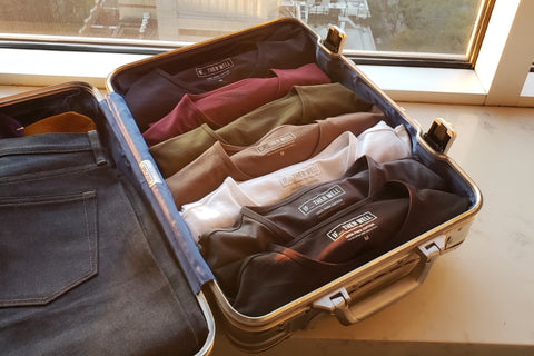 A Suitcase with a Crisp Pair of Jeans and Men's T-Shirt Bundle