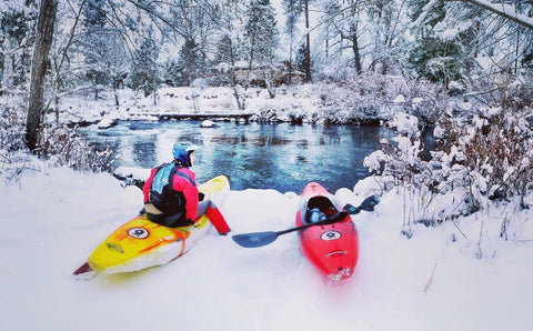 Jo whitewater kayaking on the Lower White Salmon on a snowy winter day.