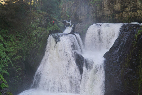 Kayaker paddling over the top part of Frustration Falls in Oregon.