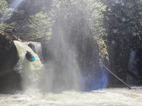Packrafter paddling over a waterfall on the Salmon River Gorge