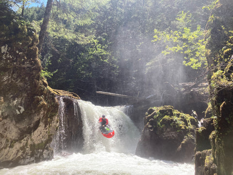 Packrafter paddling over a 10 foot waterfall in Oregon.