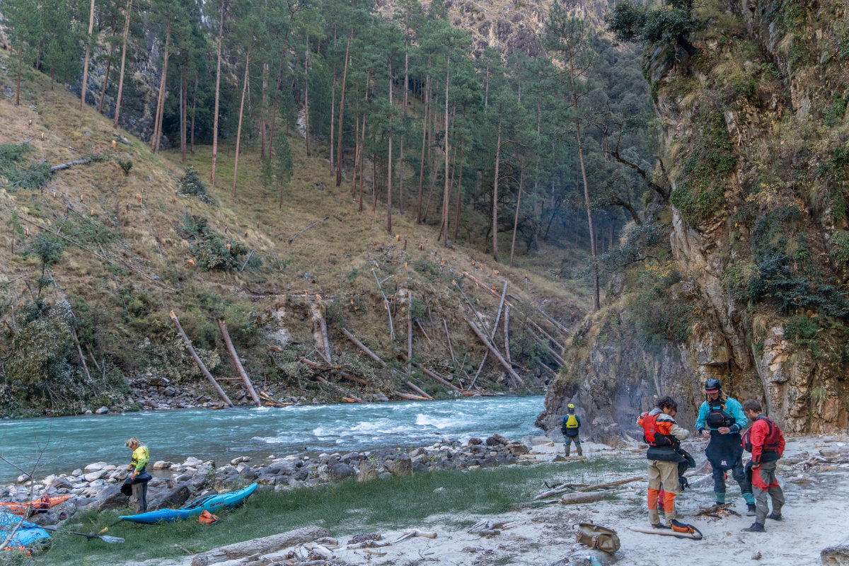 Kayakers hanging out at their camp next to a river