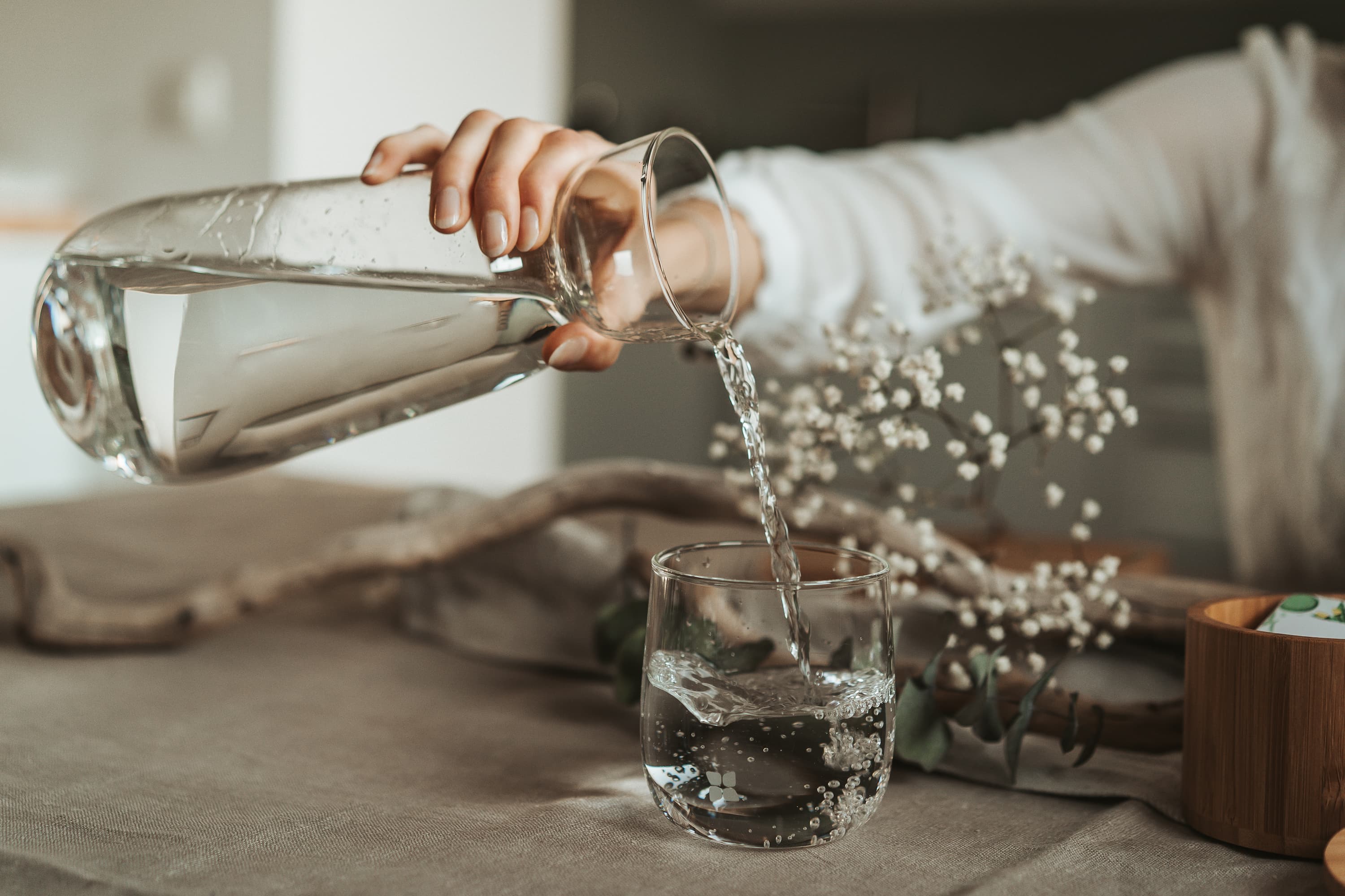 Water is being poured out of a waterdrop® Glass Carafe