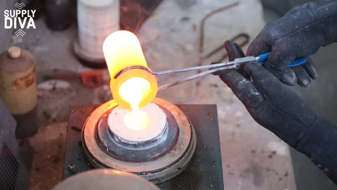 Molten metal being poured into a flask