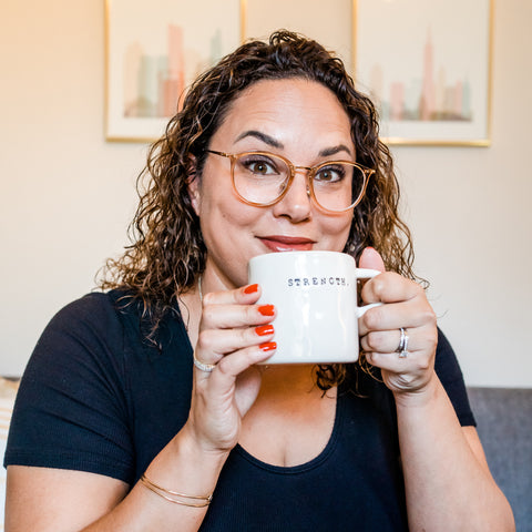 Jessica Meunier holding up cup of coffee