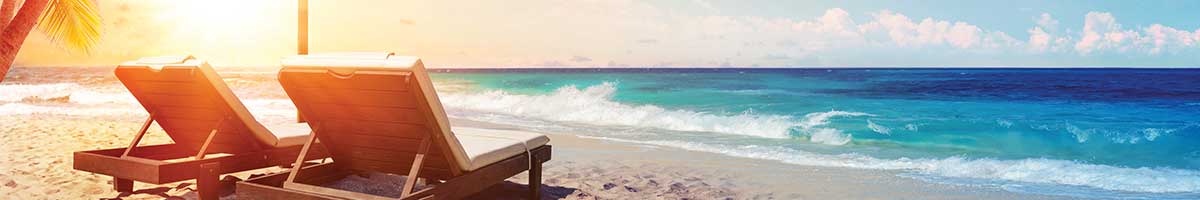 two beach chairs and a sunset behind them