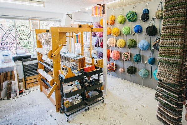 The Oxford Weaving Studio with loom and yarn on display