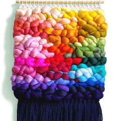 Jen Duffit from Nova Mercury weaving a rainbow wall-hanging