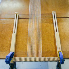 The Oxford Frame Loom attached to a table to extend the warp