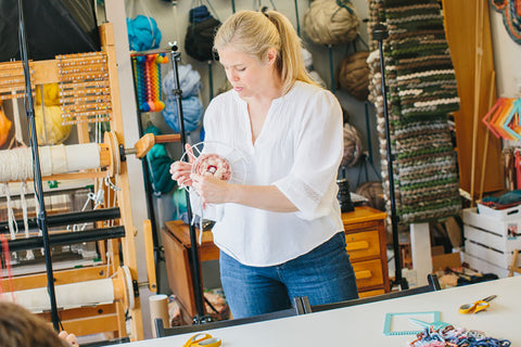 Cass demonstrating how to weave a circular shape in a workshop