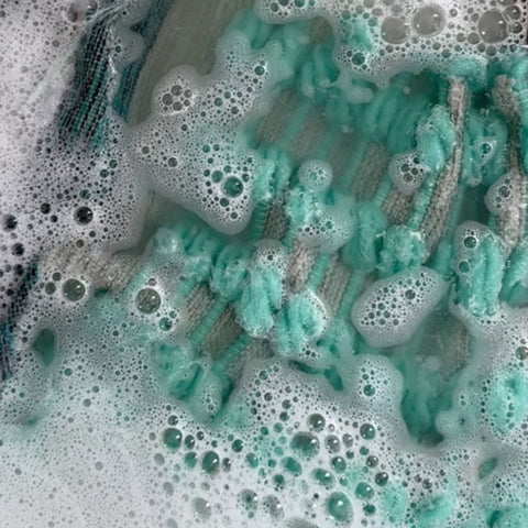 Handwoven fabric submersed in water with bubbles
