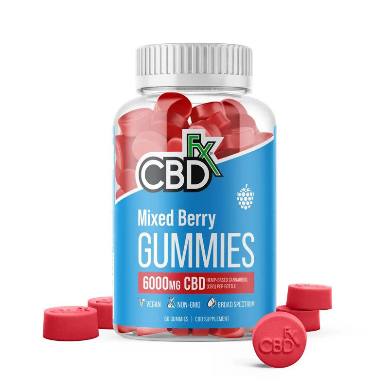 A container of CBDfx Mixed Berry gummies with a few gummies sitting around it.