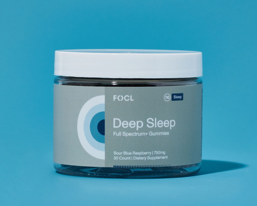 jar of FOCL Deep Sleep Gummies against blue background