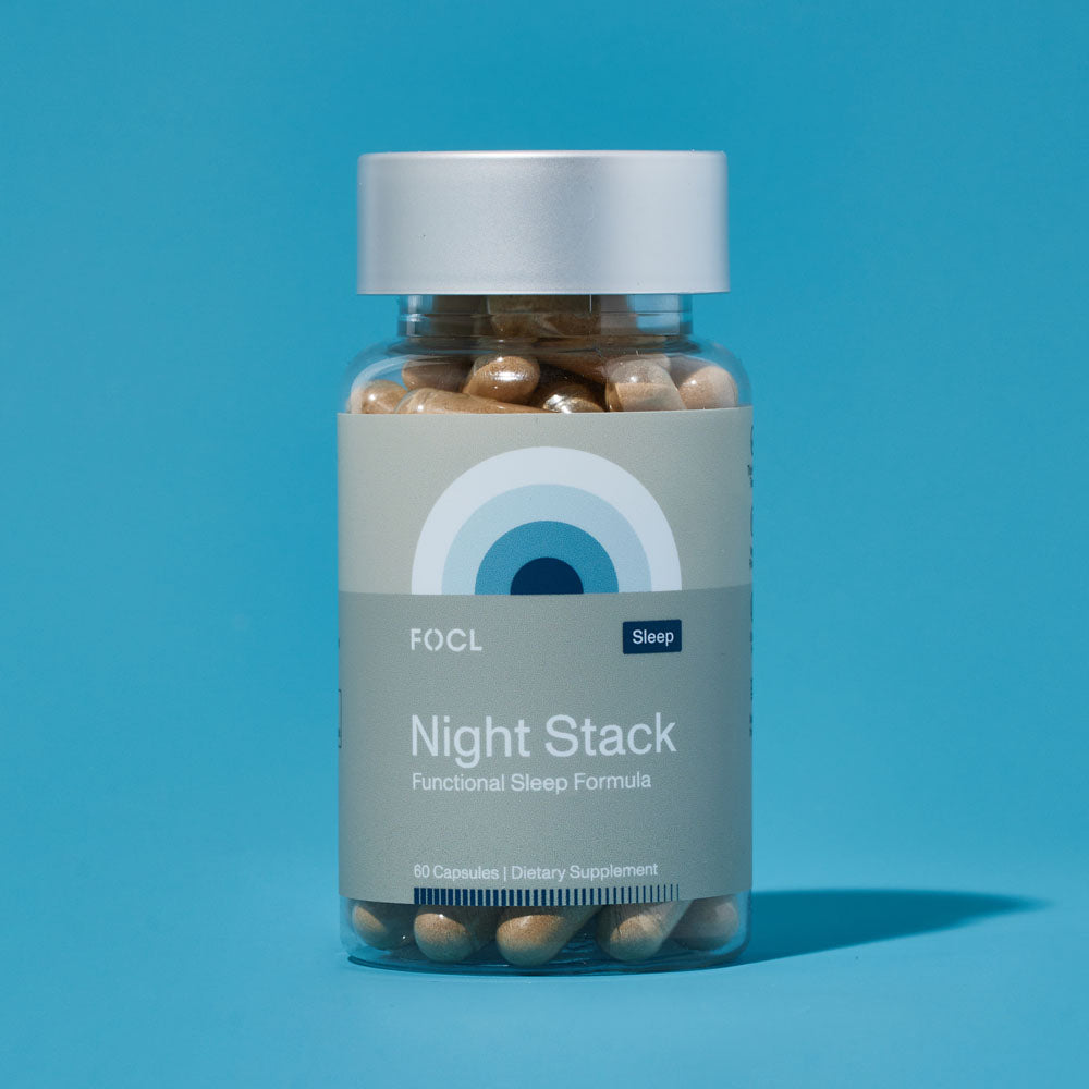 a bottle of FOCL Night Stack with Functional Sleep Formula against blue background