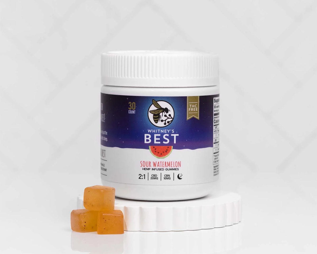 jar of Whitney's Best Sleep Support CBD + CBN Gummies in Sour Watermelon beside three orange gummies