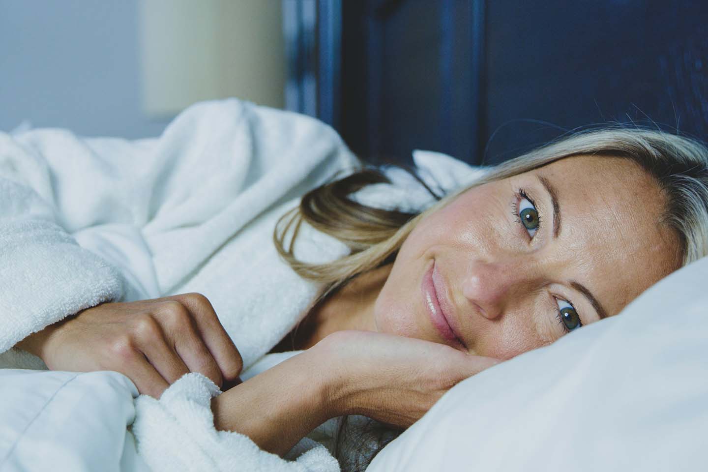 a happy woman in bed