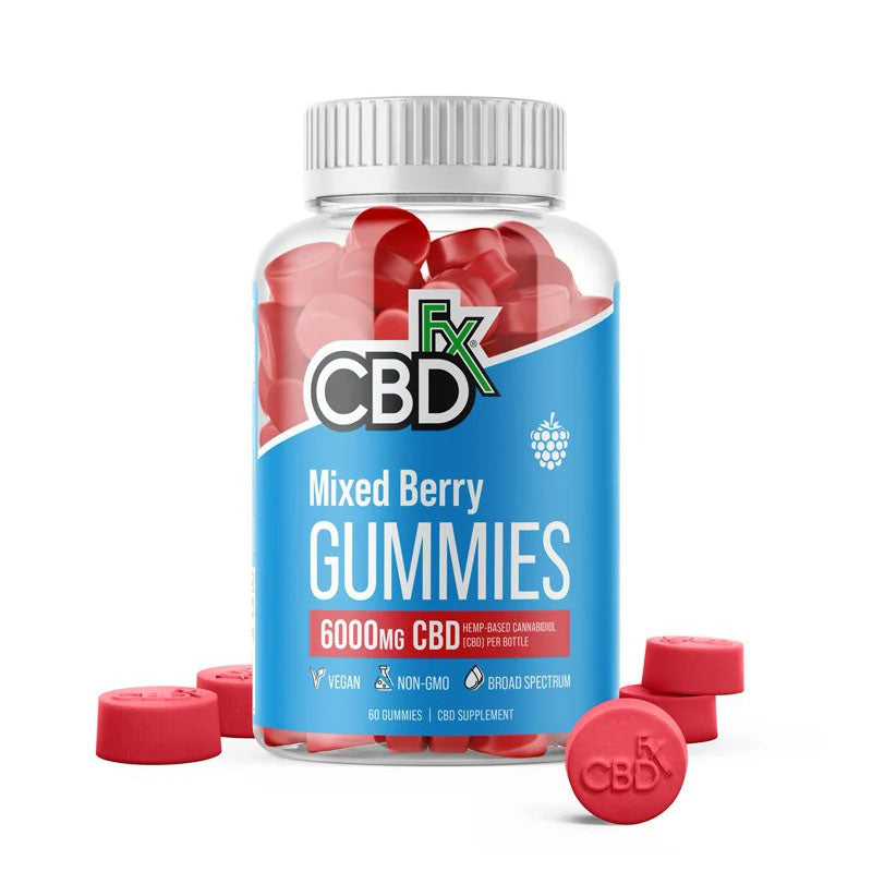 a clear bottle of CBDfx Original Mixed Berry CBD Gummies with red gummies scattered around it