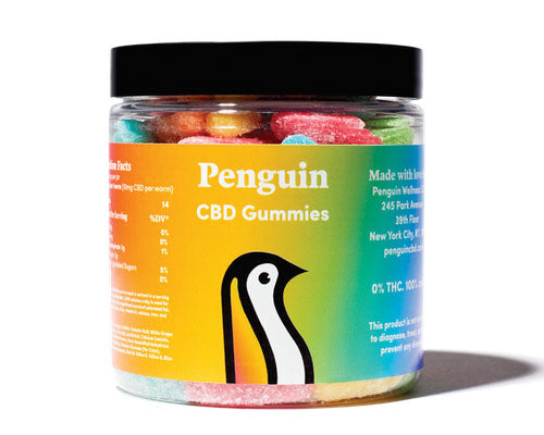 a clear jar of Penguin CBD Gummies with rainbow-colored gummies inside