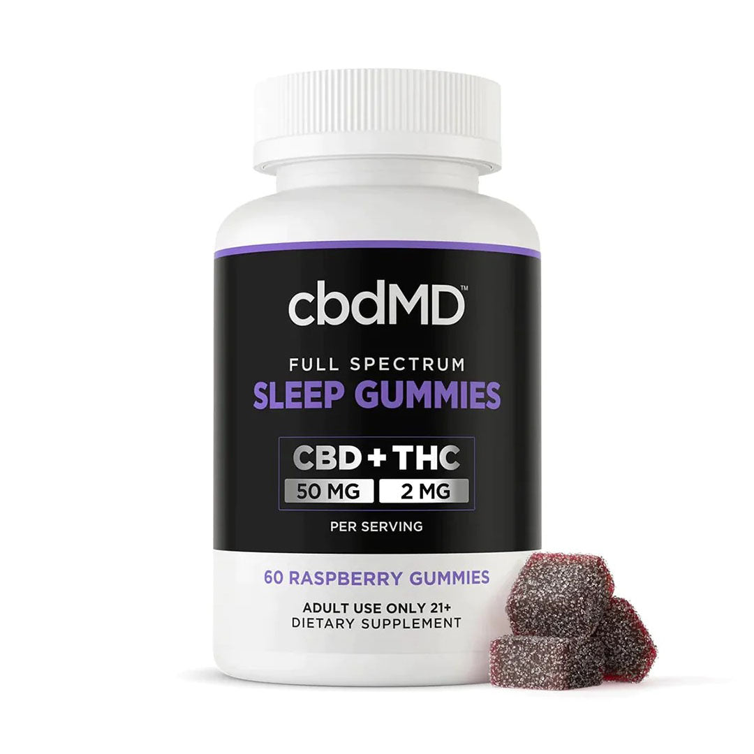 bottle of cbdMD Sleep Gummies in Raspberry beside three dark red gummies
