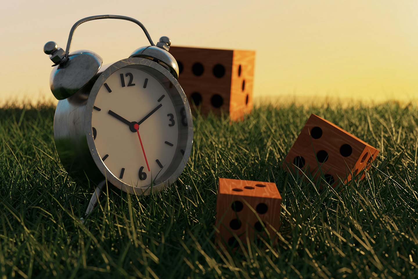 an alarm clock and three wooden dice in a grassy field