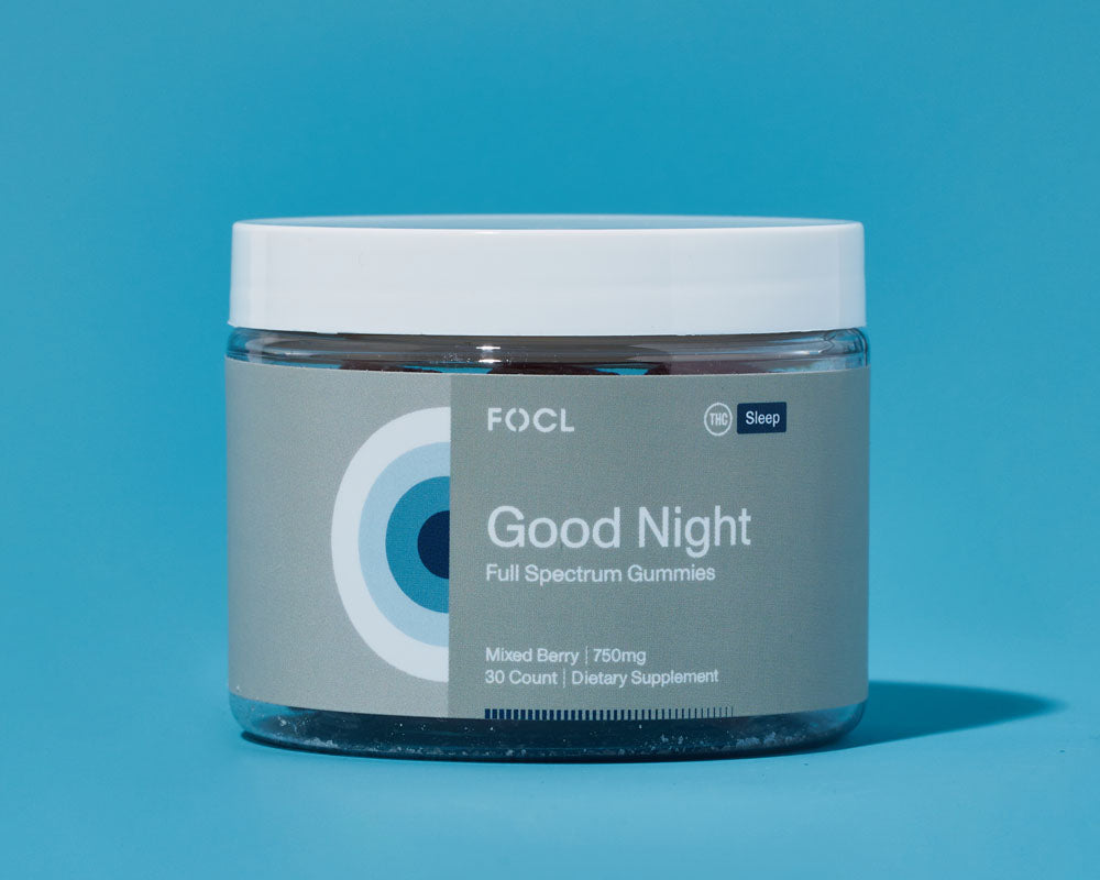 Jar of FOCL Good Night Full Spectrum Gummies against blue background